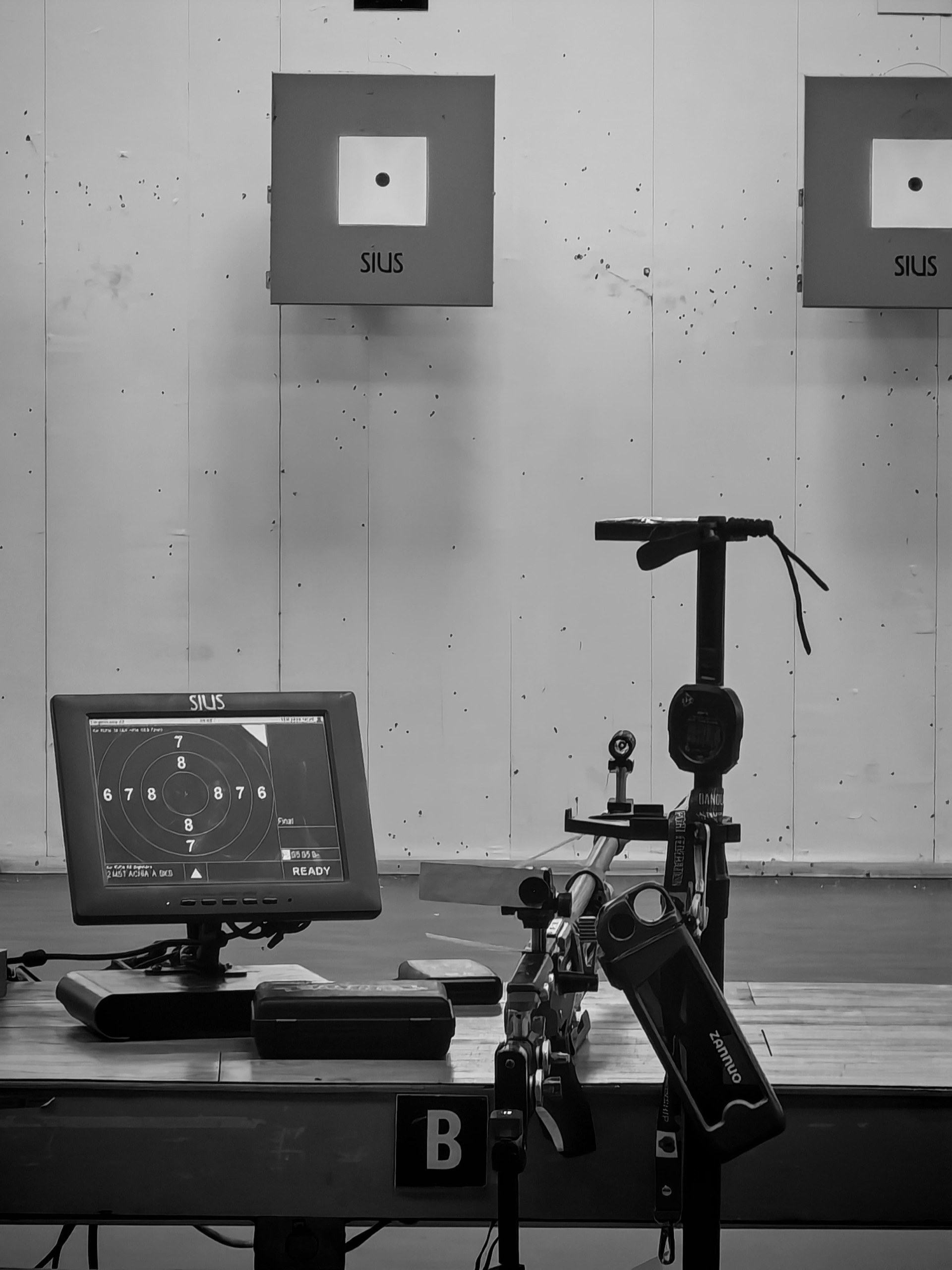 A 10m air rifle range: paper targets, electronic scoring monitor and rifle stand