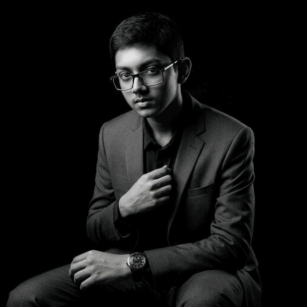 Abdullah Mohammad Zubair seated in a dark suit, looking directly at the camera